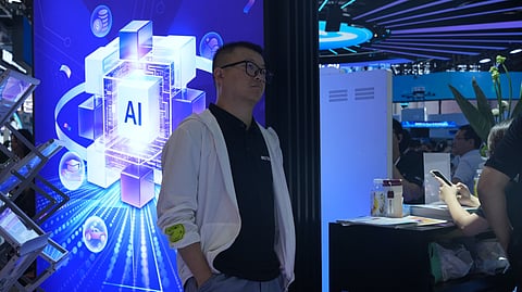 A visitor stands near a display about AI during the World AI Conference in Shanghai, China on July 17, 2026.