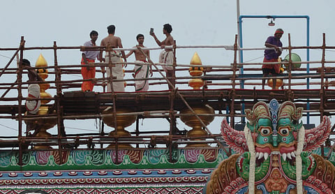 A priest on duty atop the Meenakshi temple taking a quick selfie.