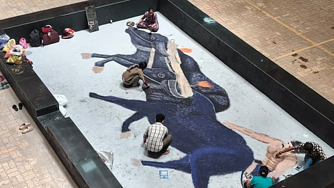 Artistes give final touches to a Kambala painting at Praja Soudha on Thursday.