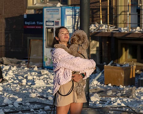 A resident stands outside a damaged building in Odesa after Russian overnight strikes on the coastal city.