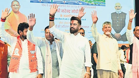 AP CM Chandrababu Naidu, along with other leaders, waving to the crowd at the ‘Varanasi-Vadnagar Seva Sankalp Abhiyan’ event in Uttar Pradesh on Thursday