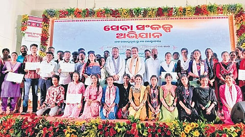 Beneficiaries with guests at the event in Sambalpur on Thursday.