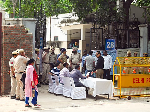 Security personnel and polling officials present outside the counting centre on the counting day of Delhi University Students’ Union (DUSU) polls, in New Delhi on Saturday.