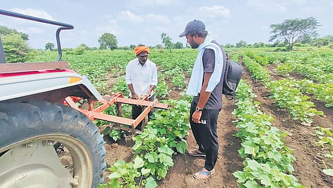 Engineer B Mohan Venkat Sai Krishna speaking with farmer.