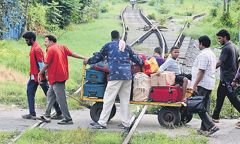 Elderly persons and children being transported on a luggage trolley at Tambaram railway station, which witnesses a daily footfall of around 1.78 lakh