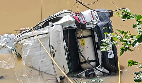 Wreckage of a car lies in a swollen drain after an accident, at Nalkheda town, in Agar Malwa district, Madhya Pradesh, Saturday, Sept. 19, 2026. At least eight people, among them three children and two women, were killed in the incident in the early hours of Saturday, police said.
