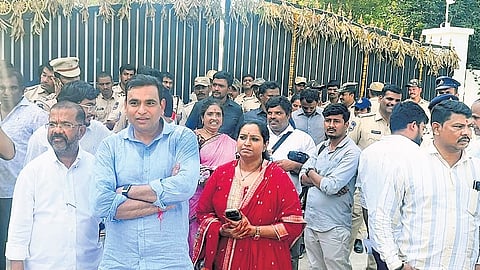 Congress legislators stand in front of the gates of Janwada farmhouse on outskirts of Hyderabad on Saturday.