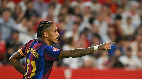 Barcelona's Raphinha celebrates after scoring a goal during the Spanish league football match between Sevilla FC and FC Barcelona at the Ramon Sanchez Pizjuan stadium in Seville on September 19, 2026