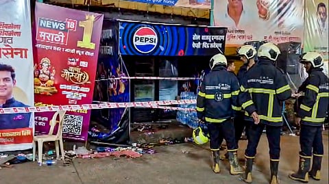 Rescue personnel stand near a sealed area after an electrocution incident near a Ganapati pandal, at Lalbaug area, in Mumbai, Sunday, Sept. 20, 2026.