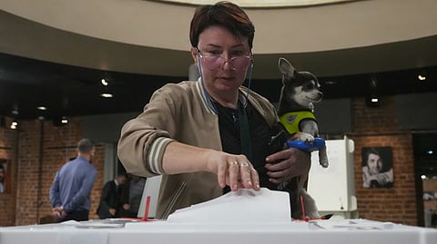 A voter casts a ballot in the parliamentary election in Moscow, Sunday, Sept. 20, 2026.