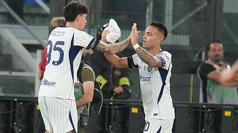 Inter Milan's Lautaro Martinez, right, celebrates with his teammate Alessandro Bastoni after scoring his side's second goal during the Series A soccer match between Roma and Inter Milan in Rome, Saturday, Sept. 19, 2026.