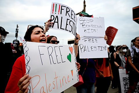 Pro-Palestinian demonstrators hold signs during a "Free Palestine" protest before an Ed Sheeran concert in Philadelphia, Saturday, Sept. 19, 2026.