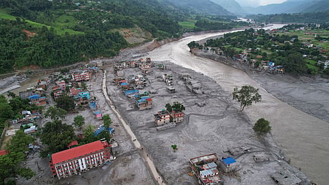 Homes are engulfed in mud in the aftermath of flash flooding along the Trishuli River in the Devighat area of Nuwakot district, Nepal, Aug. 29, 2026.