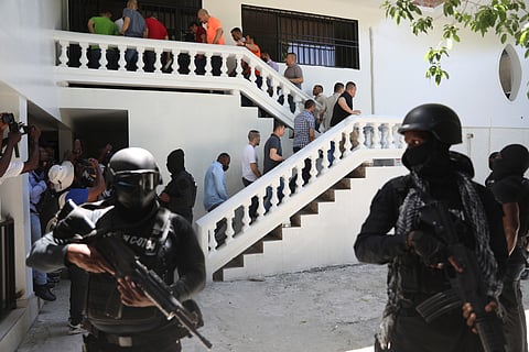 Colombians and Haitians who are accused of involvement in the 2021 assassination of Haitian President Jovenel Moise are escorted in handcuffs to their court hearing in Port-au-Prince, Haiti, May 26, 2025