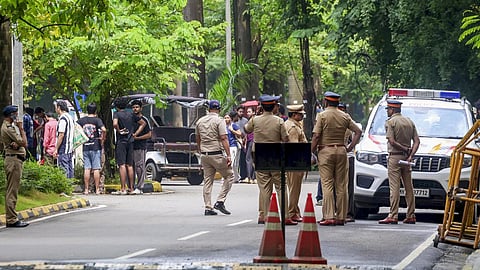 Police personnel stand guard as students protest following the death of a 22-year-old IIT Bombay student at the Powai campus in Mumbai on September 19, 2026