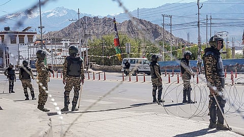 Security personnel stand guard on a road amid curfew, days after violence during protests for Ladakh statehood, in Leh, Monday, Sept. 29, 2025.