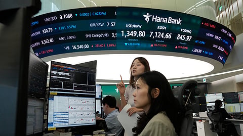 Currency traders watch monitors at the foreign exchange dealing room of the Hana Bank headquarters in Seoul, South Korea, Wednesday, Sept. 23, 2026.