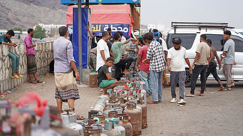 People gather to refill their gas cans at a station in Aden, Yemen, Tuesday, Sept. 15, 2026.