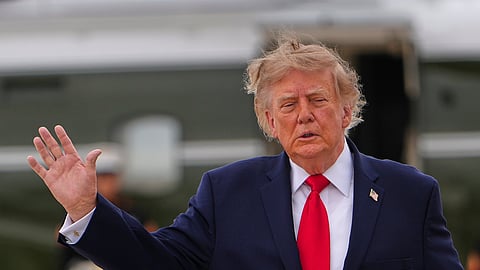 US President Donald Trump waves as he walks from Marine One to board Air Force One, Saturday, Sept. 26, 2026, at Joint Base Andrews, Md.