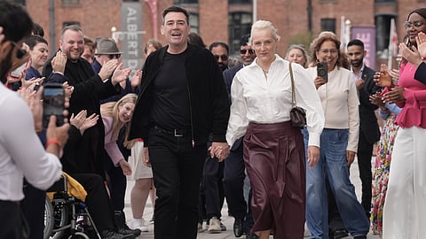 Britain's Prime Minister Andy Burnham and his wife Marie-France Van Heel arrive for the Labour Party Conference at the ACC Liverpool, in Liverpool, England,, Saturday, Sept. 26, 2026.