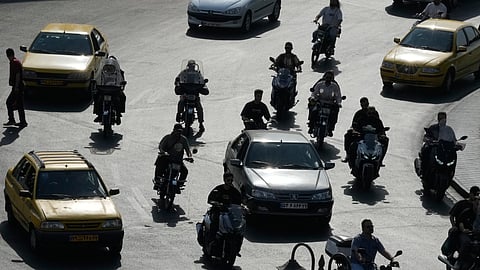 Vehicles drive at Imam Khomeini square in Tehran, Iran, Sunday, Sept. 27, 2026.