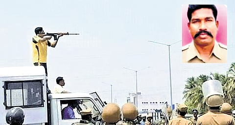 The photo shows Raja atop a police van, aiming his SLR at the crowd during the protest in Thoothukudi