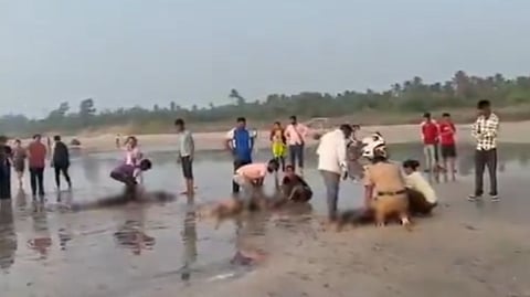 People provide first aid after eight students drowned at Diveagar beach in Raigad on Thursday, Oct. 1, 2026.