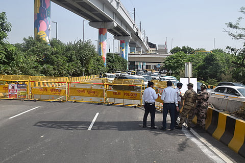 A road closed in the Mayur Vihar Phase 1 area in view of the heavy traffic rush; long snarl-ups in the Barapullah Phase 3 elevated corridor area on Thursday.