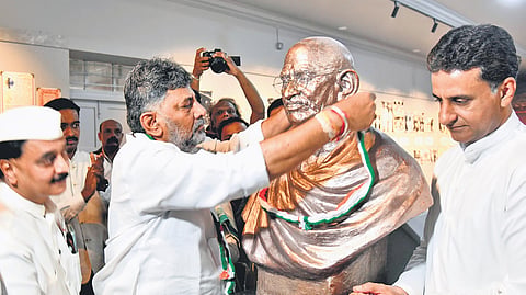 Chief Minister DK Shivakumar, along with minister Rizwan Arshad, garlands a bust of Mahatma Gandhi during the inauguration of the Gandhi Digital Museum at Gandhi Bhavan on Friday.