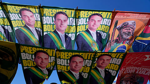 A street vendor sells campaign flags of presidential candidates Sen. Flavio Bolsonaro and current President Luiz Inacio Lula da Silva who is running for reelection in Brasilia, Brazil, Tuesday, Sept. 29, 2026.