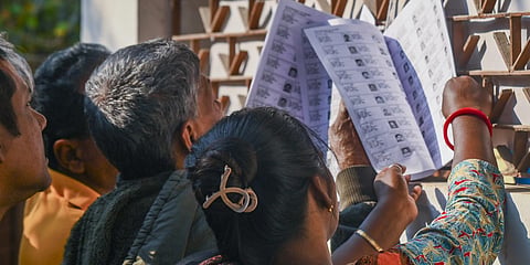Voters check their names in West Bengal's draft electoral rolls following the special intensive revision in Balurghat Dakshin Dinajpur