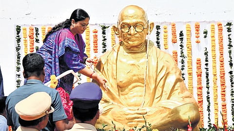 (Left) Director General of Prisons and Correctional Services Dr Soumya Mishra garlands the statue of Mahatma Gandhi at the Central Prison and Special Prison for Women in Hyderabad; Children pay floral tributes to the statue of Mahatma Gandhi on the occasion of Gandhi Jayanti on Friday in Hyderabad.