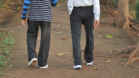 Two octogenarian walking early morning in a park at Hebbal Lake, Bengaluru