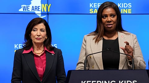 FILE - New York Gov. Kathy Hochul, left, listens as Attorney General Letitia James speaks during a news conference in New York, Oct. 11, 2023.