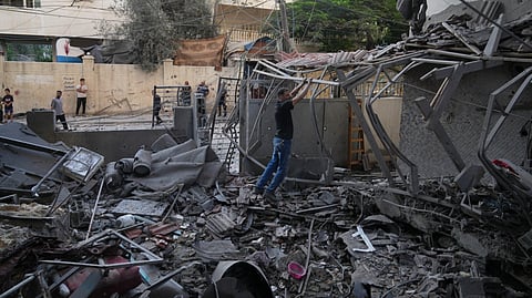 Palestinians inspect the site of an early morning Israeli airstrike in Gaza city, Saturday, Oct. 3, 2026.