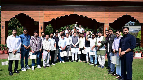 Uttarakhand Chief Minister Pushkar Singh Dhami (centre) alongwith Haryana youth.