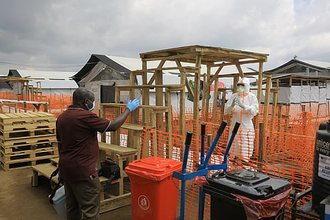 Health workers talk inside a Ebola treatment camp in Butembo, Congo, Wednesday, Sept. 30, 2026.