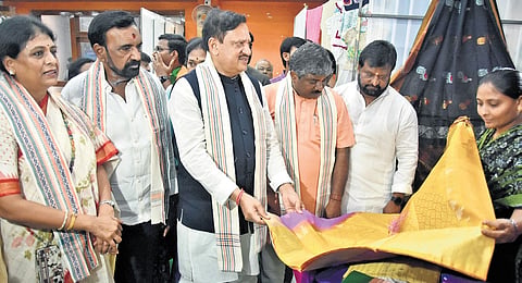 AP BJP incharge Arvind Singh Bhadoria takes a look at the exhibits in a stall after he inaugurated a Khadi Santa in Vijayawada on Friday