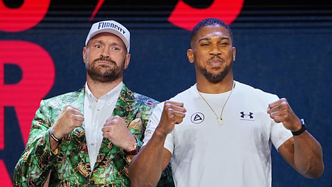 Tyson Fury, left, and Anthony Joshua, right, pose together after a Press Conference in London, Wednesday, Sept. 30, 2026, to promote their upcoming fight which will take place at the Principality Stadium in Cardiff on Dec.11.