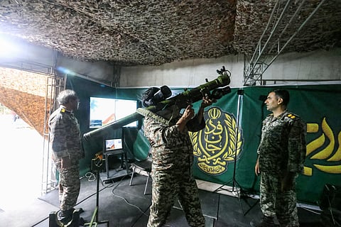 An Iranian officer demonstrates the use of a man-portable air-defense system during the inauguration of a training centre by the Iranian army for "Jan-Fadayan" (those willing to sacrifice their lives) volunteers, at Haft-e-Tir Square in central Tehran on October 3, 2026.