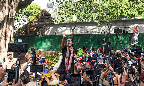 AISA President Neha Bora, along with other protesters, raises slogans during a protest near Jantar Mantar, in New Delhi on Saturday.
