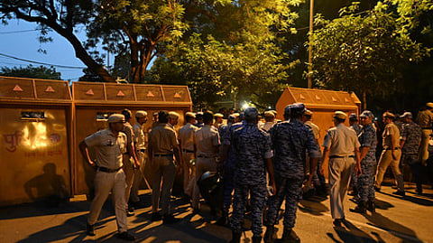 Police personnel block a road with barricades, ahead of the Cockroach Janata Party's (CJP) protest march, at the Jantar Mantar, in New Delhi