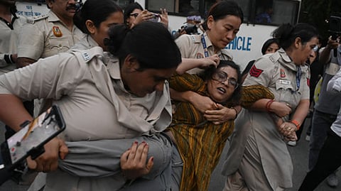 Police personnel detain members of the All India Students' Association, Students' Federation of India and other student organizations during the protests in New Delhi on Saturday