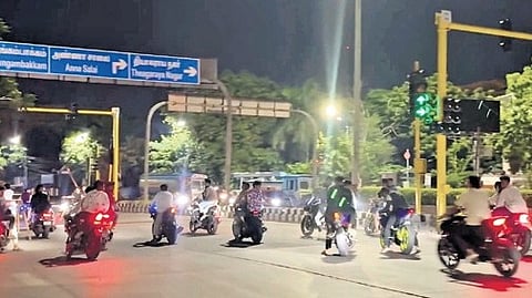 Bikers perform stunts at a traffic junction near Valluvar Kottam on Saturday.