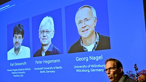 Karl Deisseroth, Peter Hegemann and Georg Nagel are shown on the screen as they are awarded the 2026 Nobel Prize in Physiology or Medicine, as announced during a press conference at the Nobel Forum at Karolinska Institutet in Stockholm, Sweden, Oct. 5, 2026.
