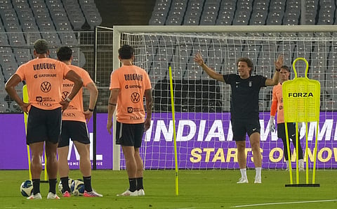 Diego Forlan (R) interacts with the players during a training session at Salt Lake Stadium on Monday