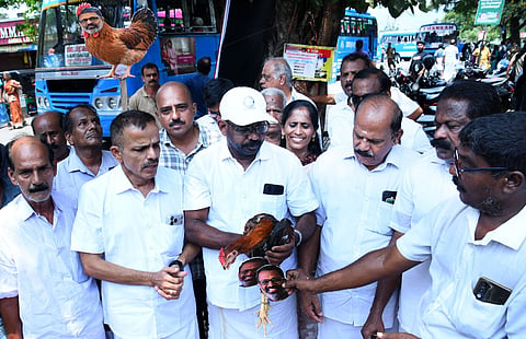Congress workers, in a symbolic protest, tying former CPM Palakkad district secretary E N Suresh Babu’s photograph to the leg of a rooster and releasing it towards the CPM office during a protest march taken out from the Palakkad DCC office to the Stadium bus stand on Monday.
