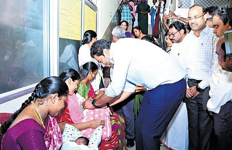 Aadhav Arjuna presents a gold ring to a newborn baby at the Urban Community Health Centre in Ayanavaram