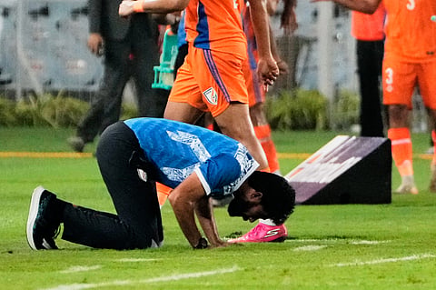 India's coach Khalil Jamal kneels after India scored a goal against Uruguay on Tuesday