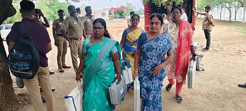 Electoral officers making arrangements at the polling booths in Dharapuram town in Tiruppur district on Monday, ahead of the bye-election
